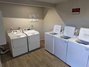 three washers and dryers sitting in a room at Central Scottsdale 2BR in a Quiet Area! in Scottsdale