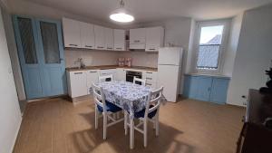 a kitchen with a table and chairs and a refrigerator at La Casetta di Treville in Ozzano Monferrato +15 photos