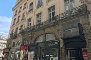 a large building with a balcony on a street at Studio lyonnais calme 4pers Jacobins-Bellecour in Lyon