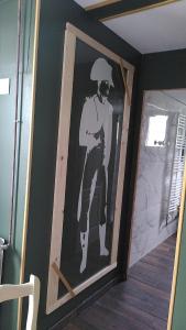 a picture of a man on a wall in a room at Au fil du temps in Amboise