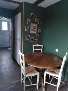 a dining room with a wooden table and chairs at Au fil du temps in Amboise