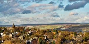 a town with trees and houses on a hill at The Signature Suite in Bradford