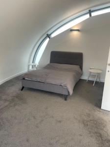 a bed in a room with an arched ceiling at The Signature Suite in Bradford