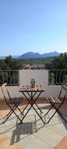 a table and chairs on a balcony with a view at Casa Bel Panorama in Orosei