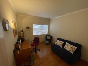 a living room with a couch and a red chair at 1 Bedroom & Office Near Caltrain and Stanford in Palo Alto