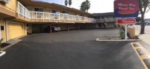 an empty parking lot in front of a hotel at Morro Bay Beach Inn in Morro Bay