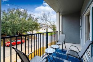 a balcony with chairs and a table and a car at Spacious New Condo! Near FtSam Houston*Alamo*Pearl in San Antonio
