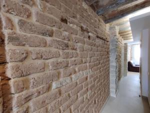 a brick wall in the hallway of a house at Antic Manresa 2 in Manresa