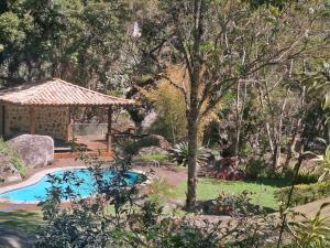 un giardino con piscina e gazebo di Casa Riacho Verde a Petrópolis