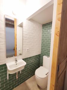 een badkamer met een wit toilet en een wastafel bij Antic Apartament in Manresa