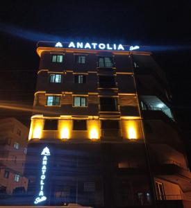 a tall building with a sign on it at night at Anatolia SUITE APART in Bostancı