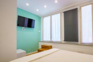 a bedroom with a bed and a flat screen tv on the wall at Sotto Sale-5 Terre affittacamere in Riomaggiore