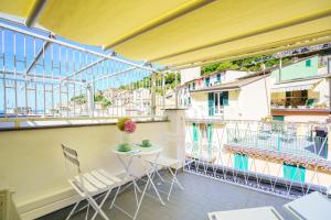 a balcony with a table and chairs on a building at Sotto Sale-5 Terre affittacamere in Riomaggiore