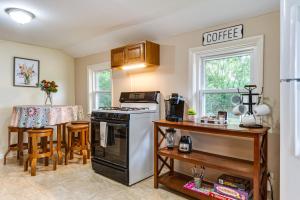 a kitchen with a stove and a counter with a table at Peaceful Franklin Cottage about 1 Mi to Downtown! in Franklin