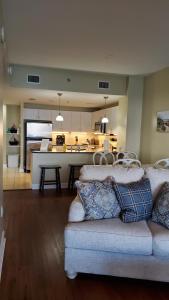 a living room with a couch and a kitchen at Grand Panama Beach Resort 1-1103 in Panama City Beach