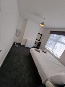 a bedroom with a large bed and a window at Luna Apartments Newcastle Gateshead 2 in Gateshead