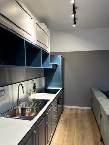 a kitchen with a sink and a counter top at Tirana Getaway Apartments - Central in Tirana