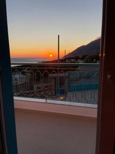 a view of the sunset from a balcony at Endless blue Apartments in Dhërmi