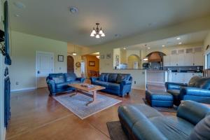 a living room with blue couches and a table at West Richland Home with Vineyard and Mountain Views! in West Richland