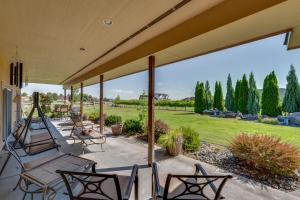 a porch with chairs and a view of a field at West Richland Home with Vineyard and Mountain Views! in West Richland