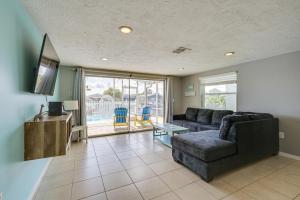 a living room with a couch and a tv at New Port Richey Oasis with Private Pool! in New Port Richey