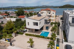 an aerial view of a house with a swimming pool at Villa FGstar in Murter