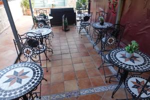 a patio with tables and chairs and a fireplace at Hotel Kursaal in Naples