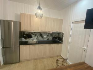 a kitchen with a refrigerator and a sink at Little Home in Potos +17 photos