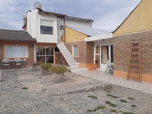 uma casa com um pátio de pedra com uma escada em CABAÑAS LOS OLIVOS em Las Grutas