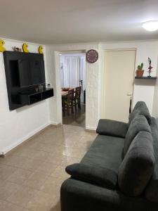 ein Wohnzimmer mit einem Sofa und einem Flachbild-TV in der Unterkunft Exclusiva casa céntrica in Chascomús
