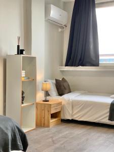 a bedroom with a bed and a dresser next to a window at Hello Studios Budget Stays Free Parking & Wifi in Stara Zagora