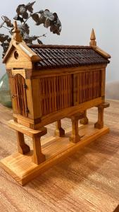 a wooden model of a house on a table at A de Juan - Tres Marias Apartments in Redondela
