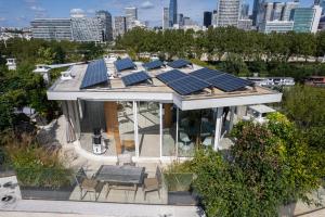 an overhead view of a house with solar panels on the roof at Splendid apartment and rooftop overlooking Paris - Neuilly - Welkeys in Neuilly-sur-Seine