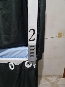 a bedroom with a bed with the number two on it at alojamentohostel in Primavera do Leste