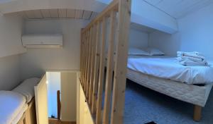 a bedroom with two bunk beds and a staircase at Maison de campagne in Tourrettes