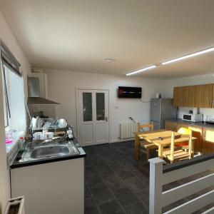 a kitchen and dining room with a sink and a table at Bethel Apartments in Leeds