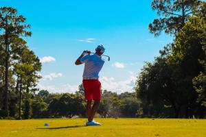 a man is playing golf on a field at Oporto, sea view and marina in Canidelo