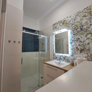 a bathroom with a shower and a sink and a mirror at Apartament Piastowski in Świeradów-Zdrój