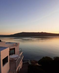 a view of a large body of water at sunset at Sunset Villa in Langebaan