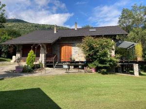 a house with a large yard in front of it at Chalet 09 in Albiès