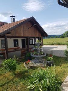 a garden with a fountain in front of a building at Holiday house with a parking space Otocac, Velebit - 19973 in Otočac