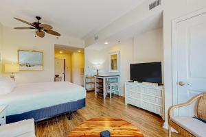 a bedroom with a bed and a flat screen tv at Luau, Unit 6108 in Destin