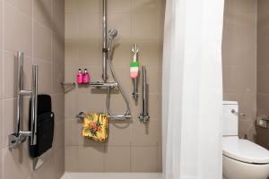 a bathroom with a toilet and a shower at Moxy Berlin Ostbahnhof in Berlin