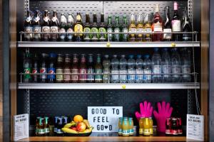 a display case with a bunch of bottles of drinks at Moxy Berlin Ostbahnhof in Berlin