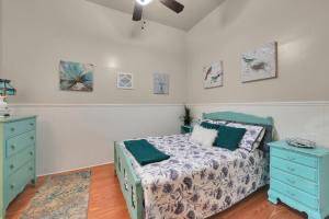 a bedroom with a bed and a blue dresser at Spacious Downtown Jackson Retreat- Historic Hangout in Jackson