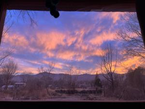 a view from a window of a sunset at LA MULITA HUMAHUACA in Humahuaca