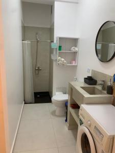 a bathroom with a sink and a toilet and a shower at CHEZ RIMA // Studio très chaleureux F1 // Très bien situé in Dakar