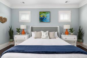 a bedroom with a large bed with two night stands at Beachfront Pool Outdoor Kitchen Firepit Putting Green in Folly Beach