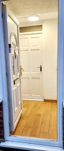 an empty room with a door and a wooden floor at Holiday Apartment in Abbey Wood