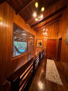 a hallway in a wooden house with a window at The Wooden House Mindo in Mindo